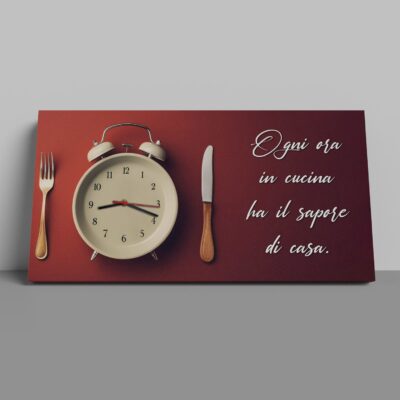 Stampa su tela con orologio analogico in stile sveglia, coltello e forchetta, ideale per decorare cucine moderne con un messaggio di calore domestico.