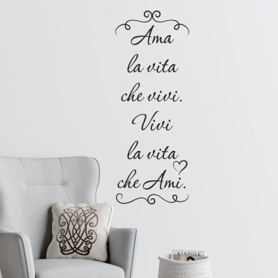 Adesivo murale frase motivazionale in vinile nero applicato su parete bianca vicino a poltrona grigia e cesto decorativo